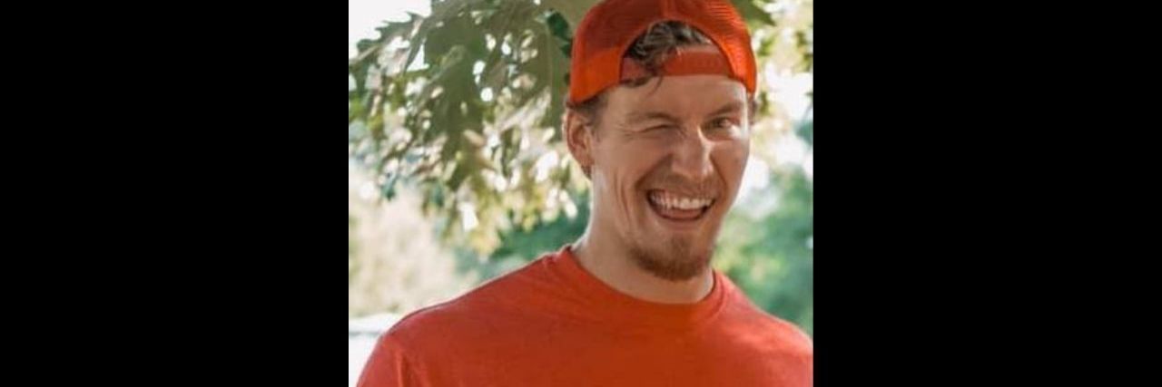 A Different Kind of Tourette Syndrome a young man winking wearing a shirt that says "I'm not winking at you. I just have Tourette's"