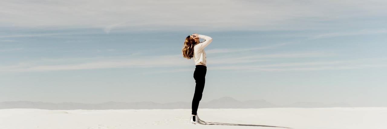 When I Struggled to Talk About My Chronic Pain Woman standing on the beach.