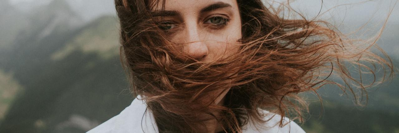 photo of a woman looking into a camera with sad eyes