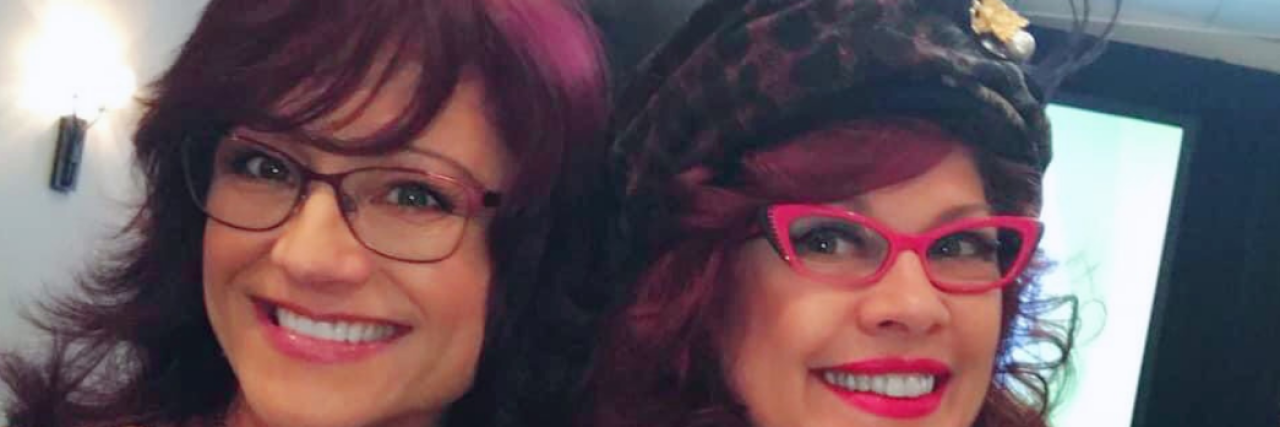 Befriending My Inner Child as Someone With Complex PTSD Naome and Maxine, contributor and her friend, smiling together wearing bright glasses and leopard print tops