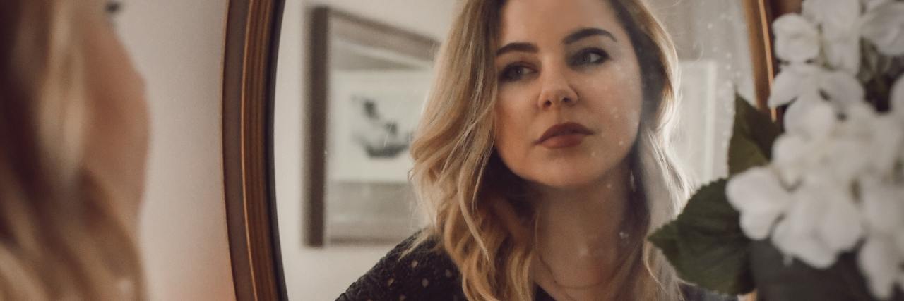 I Was in Denial About the Seriousness of My Anorexia Nervosa photo of a woman looking into a dressing table mirror