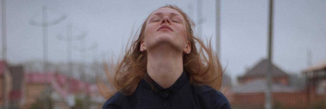 Do You Have To Tell Medical Staff Details of Your Trauma? photo of woman with her head raised to the sky, eyes closed, in the rain