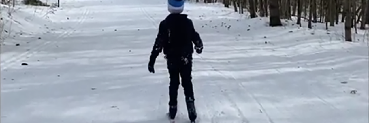 Celebrating Cerebral Palsy Awareness Month With My Son Sammy skiing, viewed from the back.