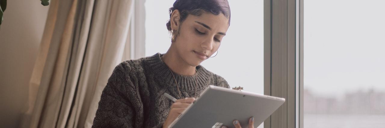 Remote Jobs for People With a Disability or Chronic Illness A woman working on a tablet