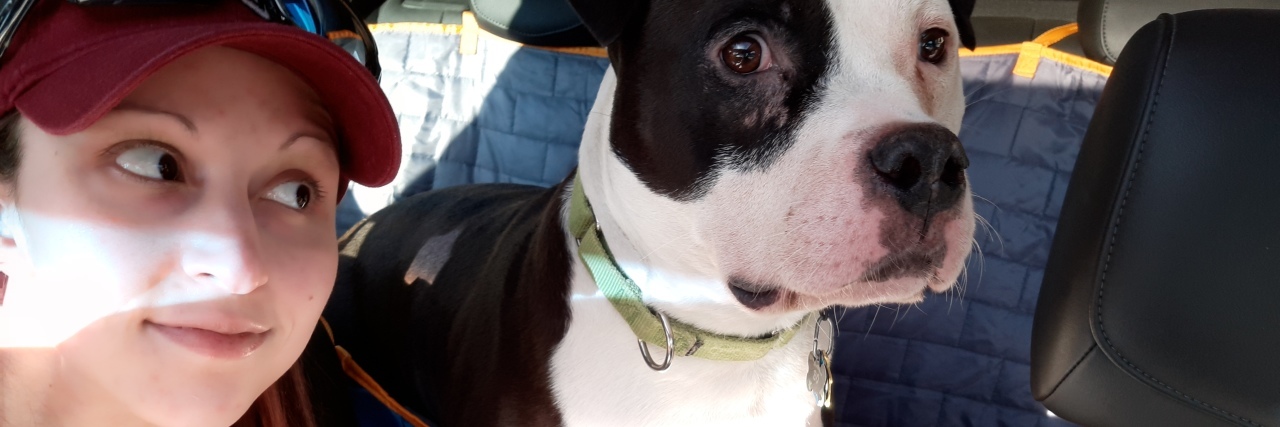What I Mean When I Say I Don't Know Who I Am Without Depression photo of the contributor looking over her shoulder at her dog in the back seat of a car