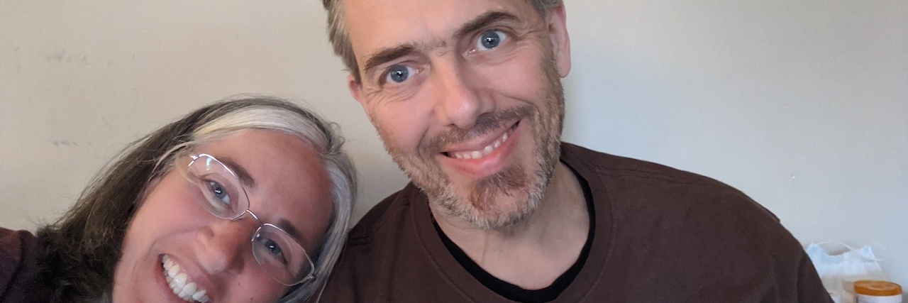 The Pandemic Likely Saved My Husband's Life Following a Stroke Photo of contributor with her husband, both smiling at the camera