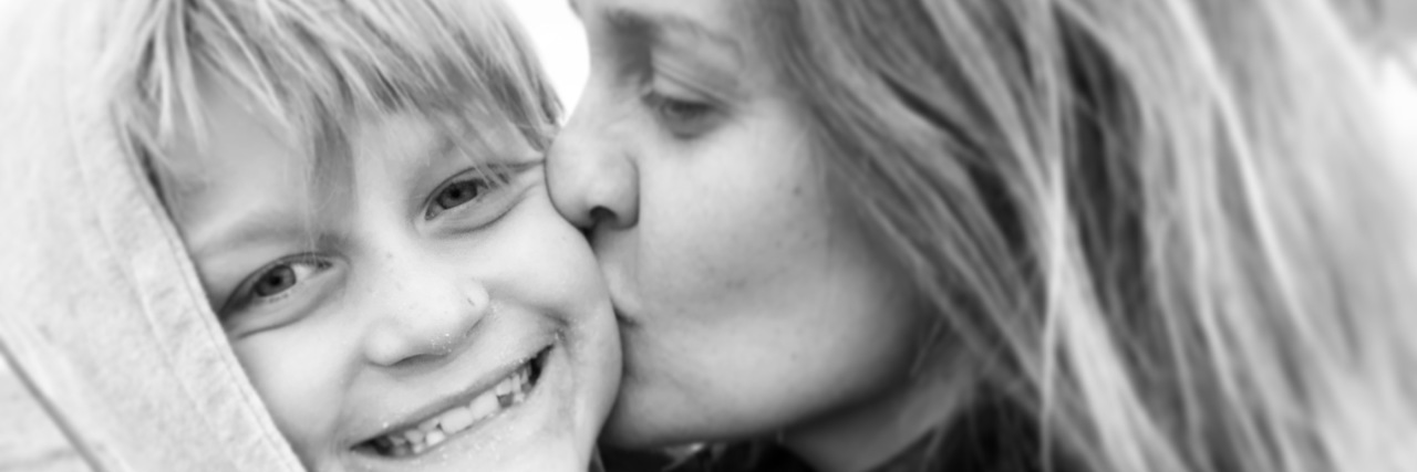 My Son on the Autism Spectrum Doesn't Fit the Mold -- and That's OK JJ gives her son a kiss.