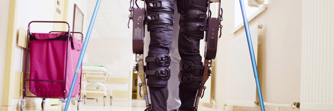 Man using exoskeleton in rehabilitation clinic.