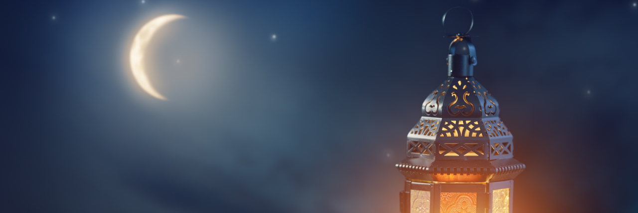 Modifying My Ramadan Fast as a Muslim With Health Conditions Ornamental Arabic lantern with burning candle glowing at night.