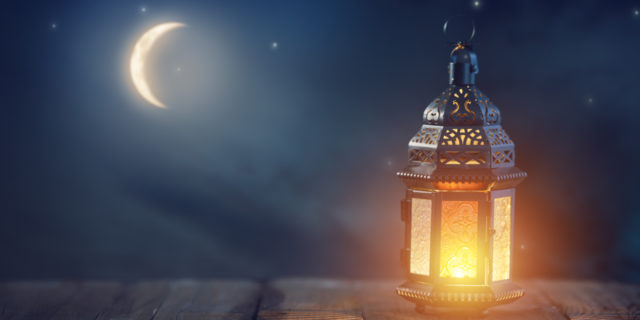 4 Surprising Health Impacts of Fasting During Ramadan as a Muslim With Health Conditions Ornamental Arabic lantern with burning candle glowing at night.