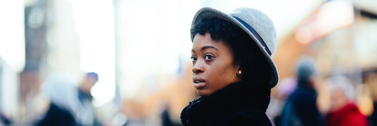 When Healing Happens Outside of Therapy Portrait of a Black woman in faux fur coat and stylish hat walking on a busy big city street
