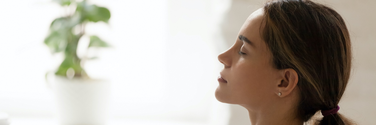 Profile of woman with closed eyes, leaning back peacefully