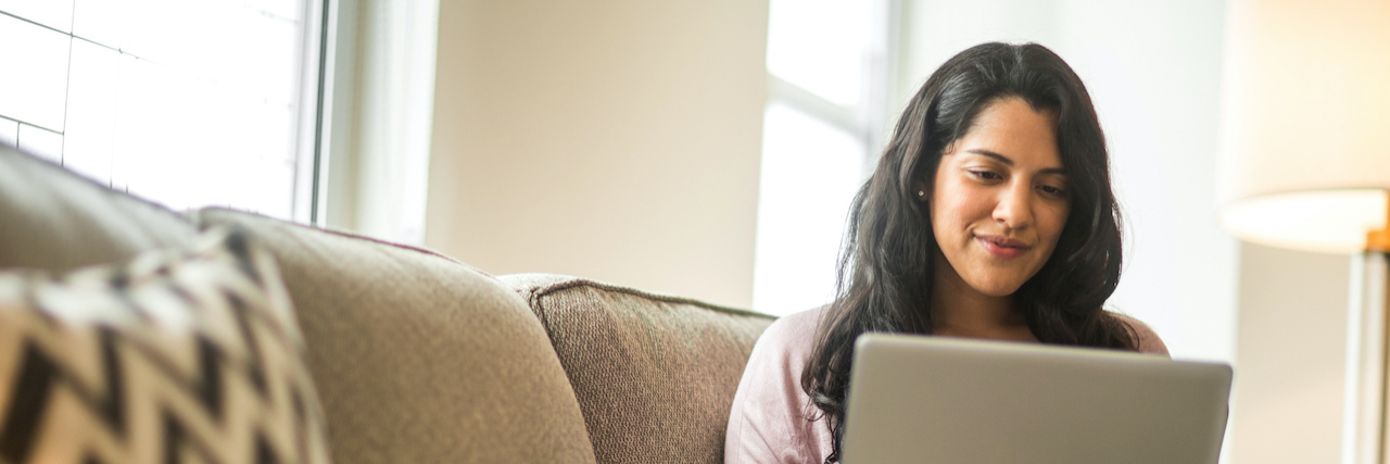 Advice for Those Struggling With Post-COVID Conditions and Symptoms Photo of woman at home on her laptop