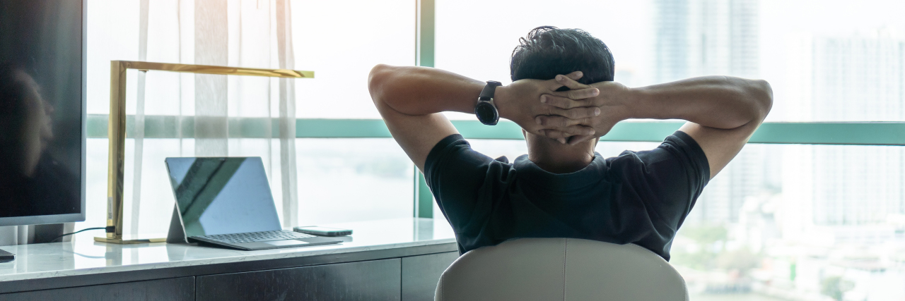 What Marketing and Sales Can Teach Us About Self-Care a man sitting at a home office desk looking out the window