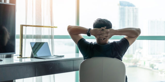 What Marketing and Sales Can Teach Us About Self-Care a man sitting at a home office desk looking out the window