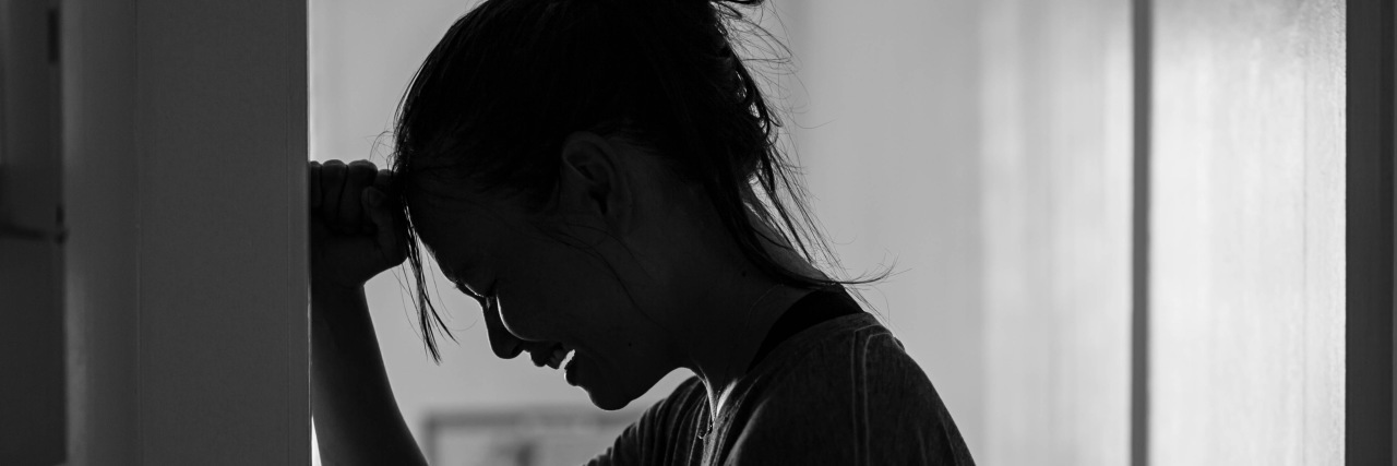 Autistic Meltdowns: What Neurotypical People Need to Know Woman crying and pounding the wall.