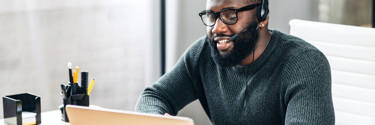 April 2021: Remote Jobs for People With Disability or Chronic Illness A man working from home with a headset on