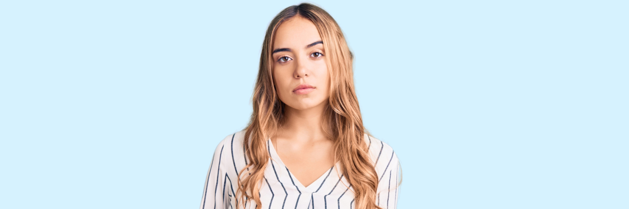 People in Mental Health Crises Need Alternatives to Going to the ER A young white woman in a striped blouse staring straight into the camera with a serious expression