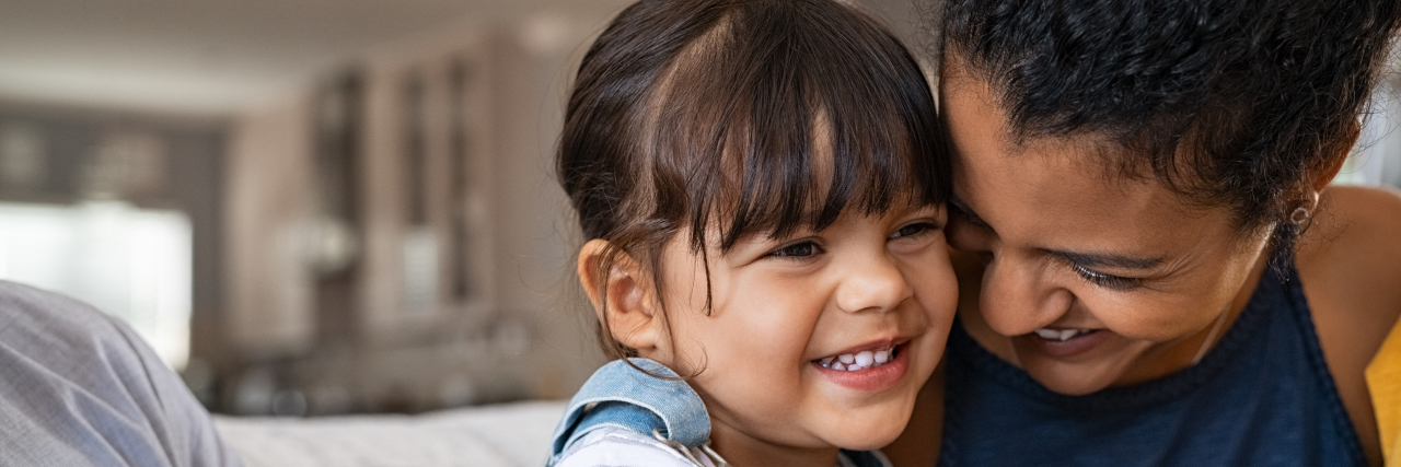 How Parents Can Model Resilience to Support Kids During the Pandemic Mother hugging young daughter.