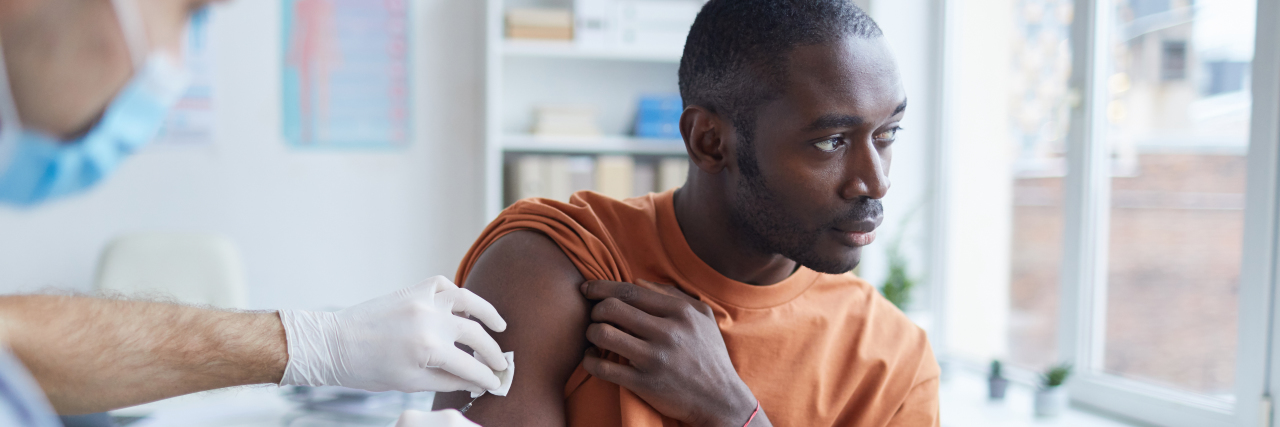 Pfizer's COVID-19 Vaccine Effective for People With Chronic Illness Black man receiving a vaccine