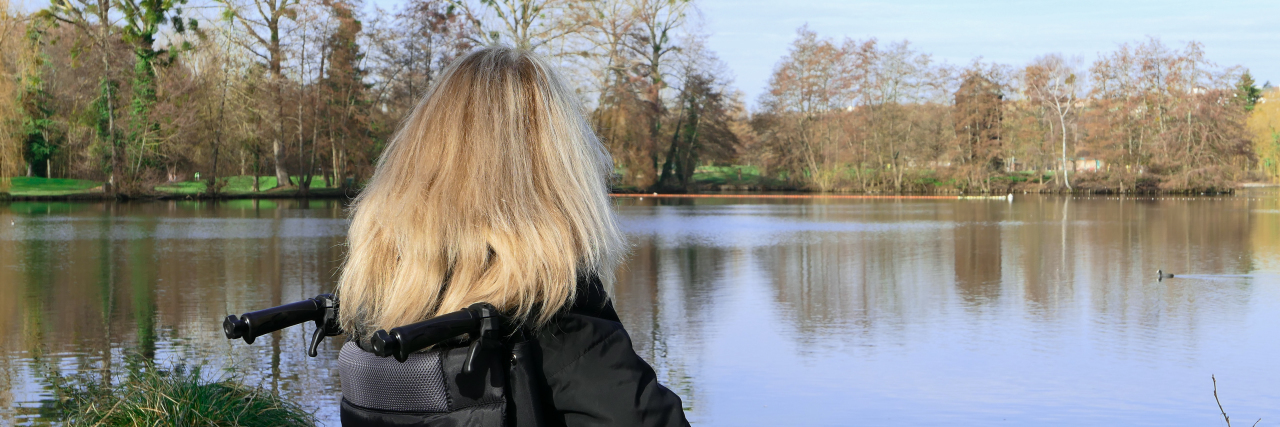 Learning to Be a Self-Advocate as a Person With a Disability A woman in a wheelchair outside by a lake.