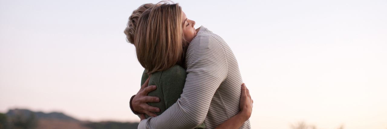 How to React If Someone Opens Up to You About Their Suicidal Thoughts A young white woman and man with their arms wrapped around each other outside