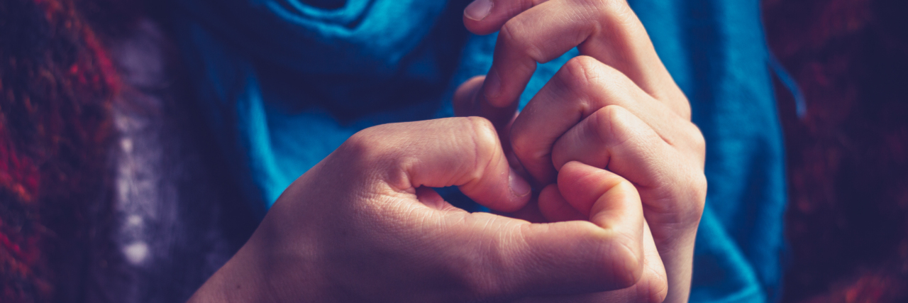 Finding the Root of My Dermatillomania a woman's hand picking