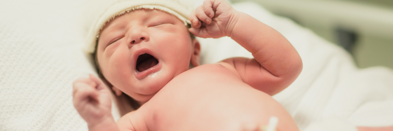 A newborn baby yarning.