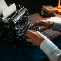 Man using old-fashioned typewriter.