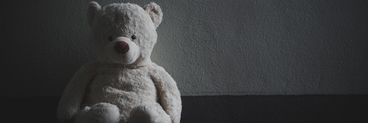 The Death of a Child: When Others Rank Your Grief a black and white teddy bear in an empty space