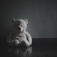 a black and white teddy bear in an empty space