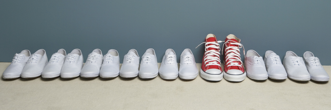 I Am Disabled, but Nothing Is 'Wrong' With Me Red Converse shoes in a row of white Keds.