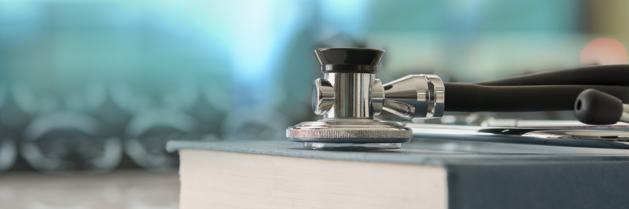 Stethoscope on top of books.