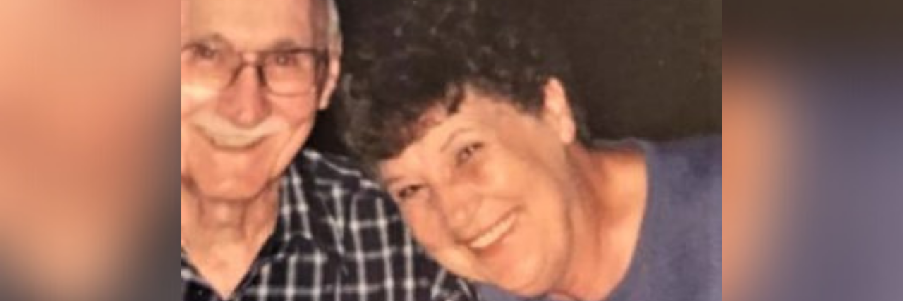 My Mental Illnesses Actually Helped Prepare Me for Grief Photo of author's grandma and grandpa, an older white man with glasses smiling and his wife, an older white woman with short curly hair smiling next to him