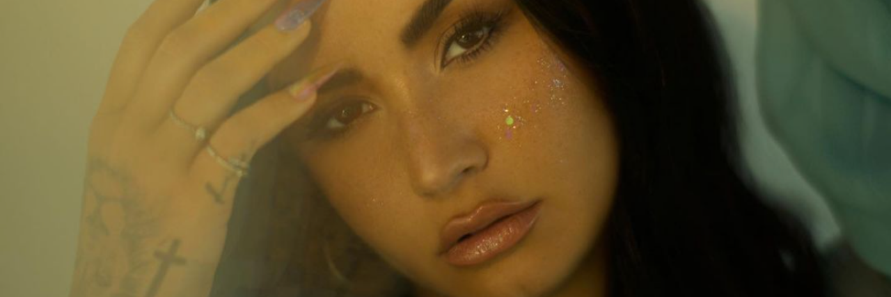 Mental Health Takeaway From Demi Lovato's 'The Art of Starting Over' photo of Demi Lovato posing for the camera with her hand raised to her head