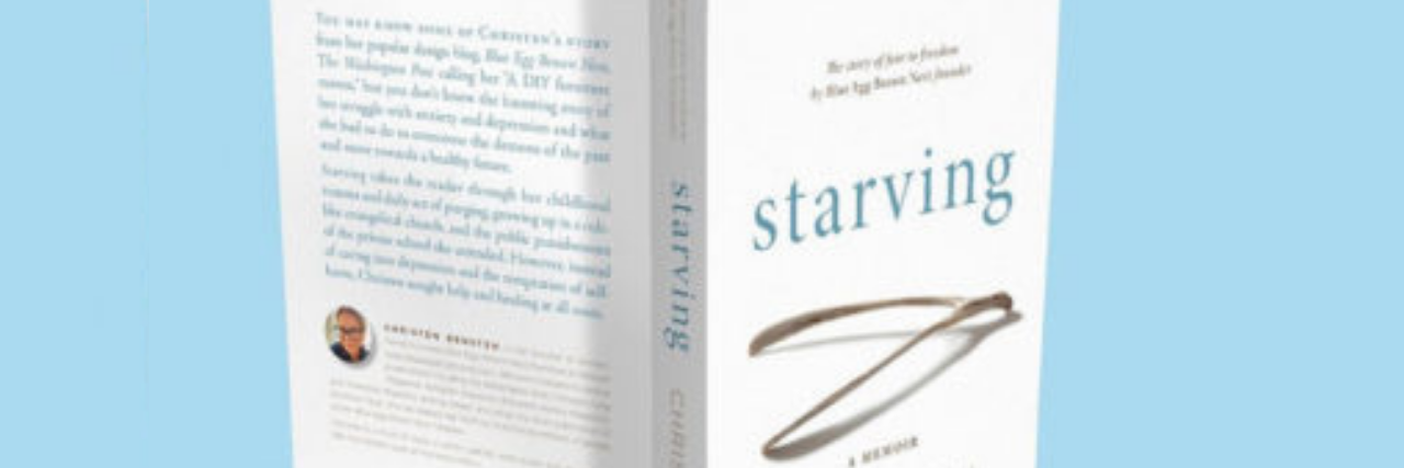Photo of the author's memoir, "Starving" standing up on a blue background