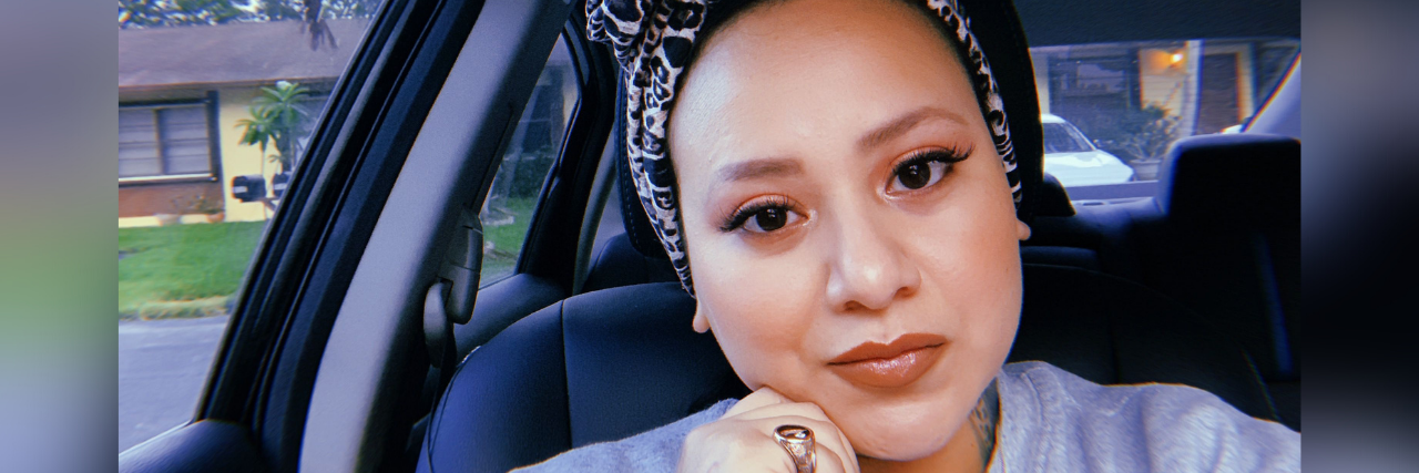 You Don't Know the Pain My Body Has Endured With Chronic Illness Selfie of author, a Hispanic woman smiling in her car