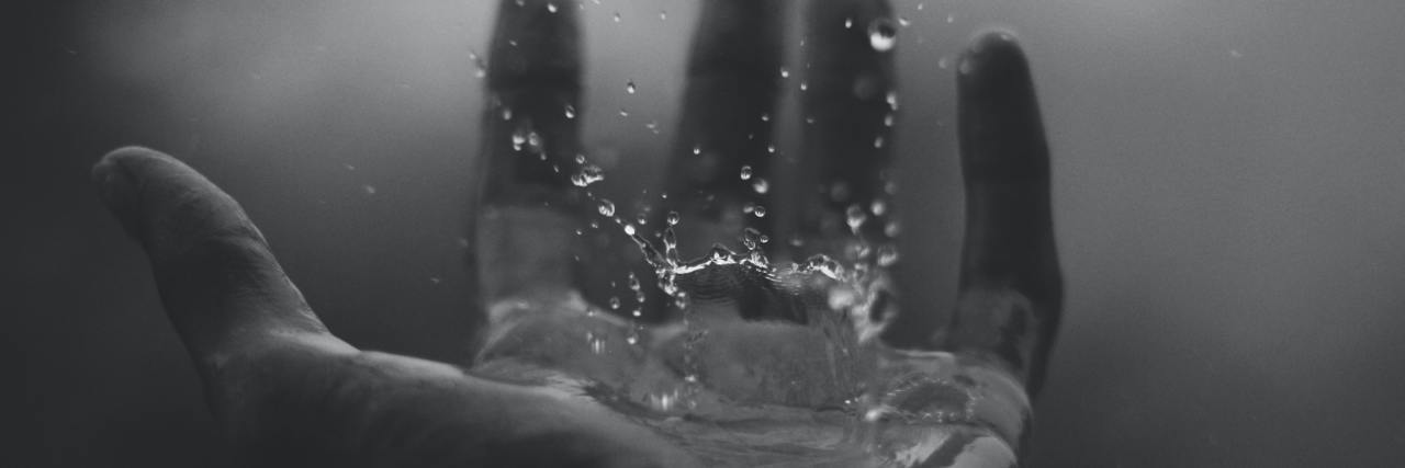 How To Navigate Trauma Triggers black and white photo of hands under running water