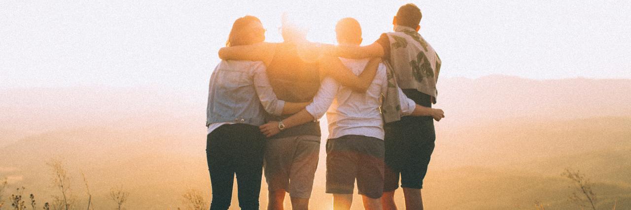6 Ways You Can Support Sexual Assault Survivors This Sexual Assault Awareness Month photo of four people standing on a cliff at sunset with arms around each other