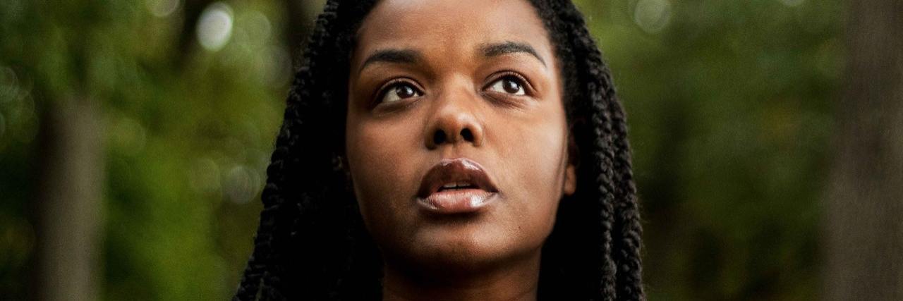 Ways to Manage Post-Derek Chauvin Guilty Verdict Emotions A Black woman looking up, outside