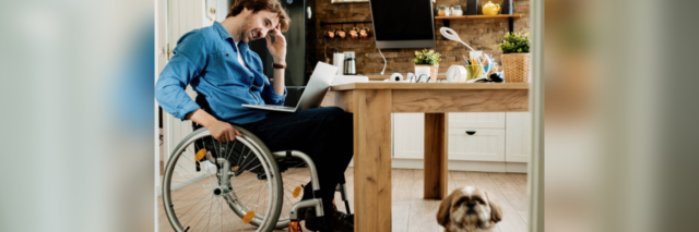 Man in wheelchair working from home.
