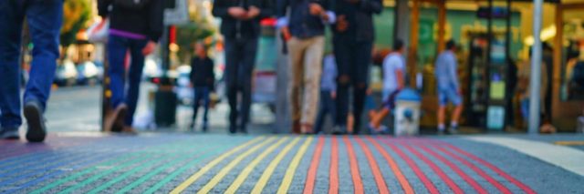 Rainbow painted stripes on sidewalk in New York City.