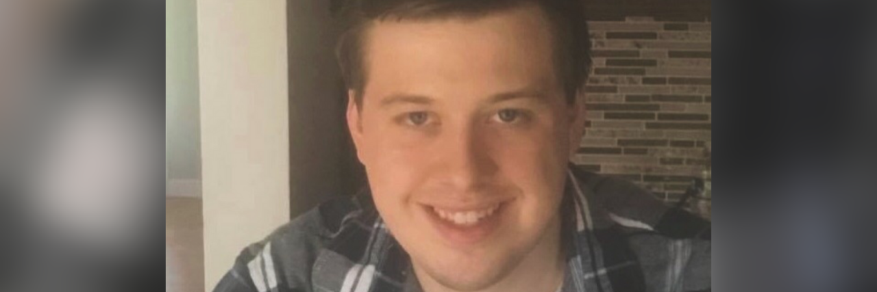 What Having Autism Means to Me Zach Smith wearing a plaid shirt.