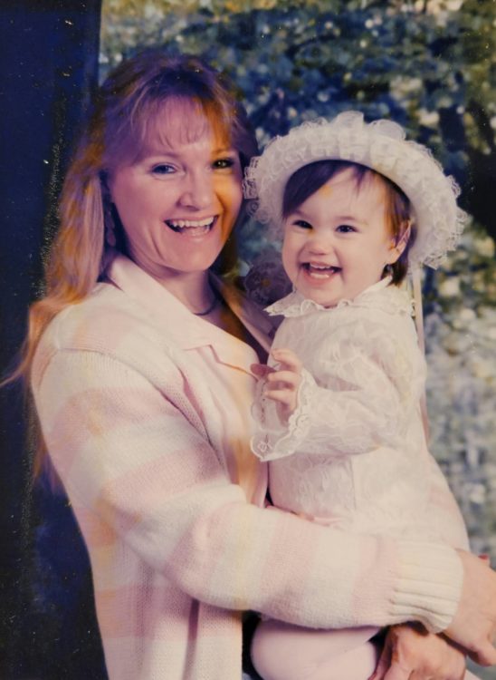 Contributor as a young child being held by her mother, both with big smiles