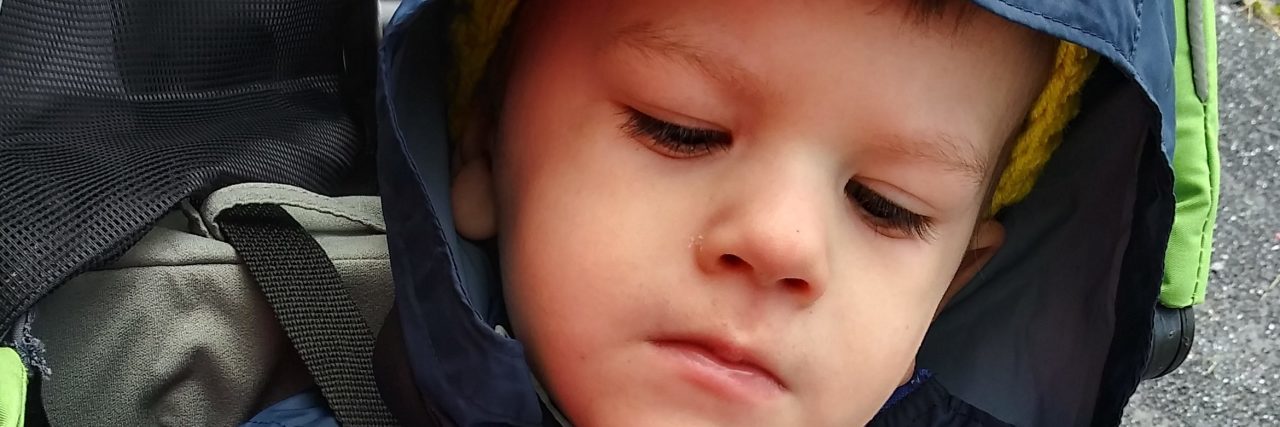 5 Tips for Adventuring With a Child With a Disability Child in a carrier on a hike.