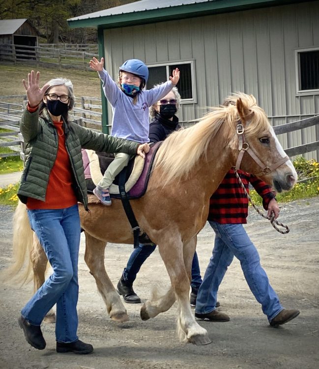 Lily riding a horse.