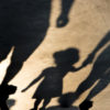 shadow silhouette of mother and daughter holding hands