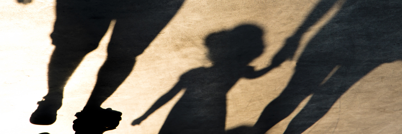 What It's Like Co-Parenting With a Narcissist shadow silhouette of mother and daughter holding hands