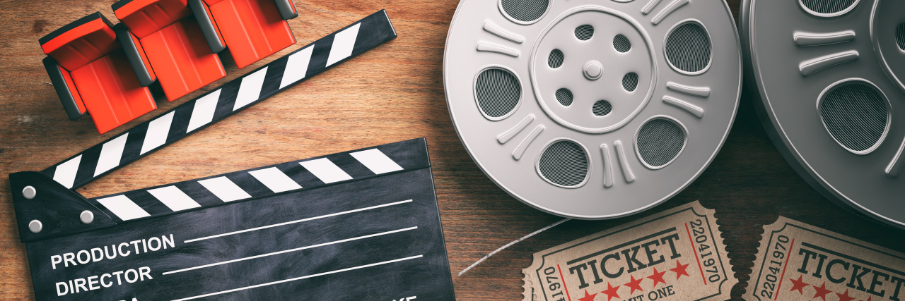 The ReelAbilities Film Festival Made Me Feel Seen and Valued Film reels with retro cinema tickets, movie clapper and red theater seats on wooden background.