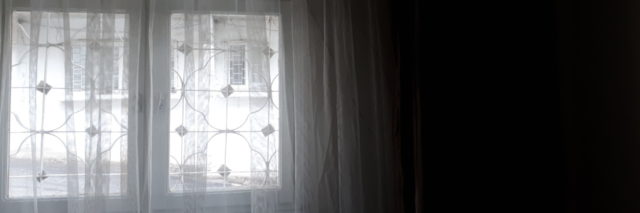 a bright window shining through a dark room